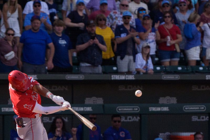 Feb 27, 2025; Mesa, Arizona, USA; Los Angeles Angels infielder Kyren Paris (19) hits a home run in the top of the ninth with two outs during a spring training game against the Chicago Cubs at Sloan Park to tie the game 4-4. Mandatory Credit: Allan Henry-Imagn Images
