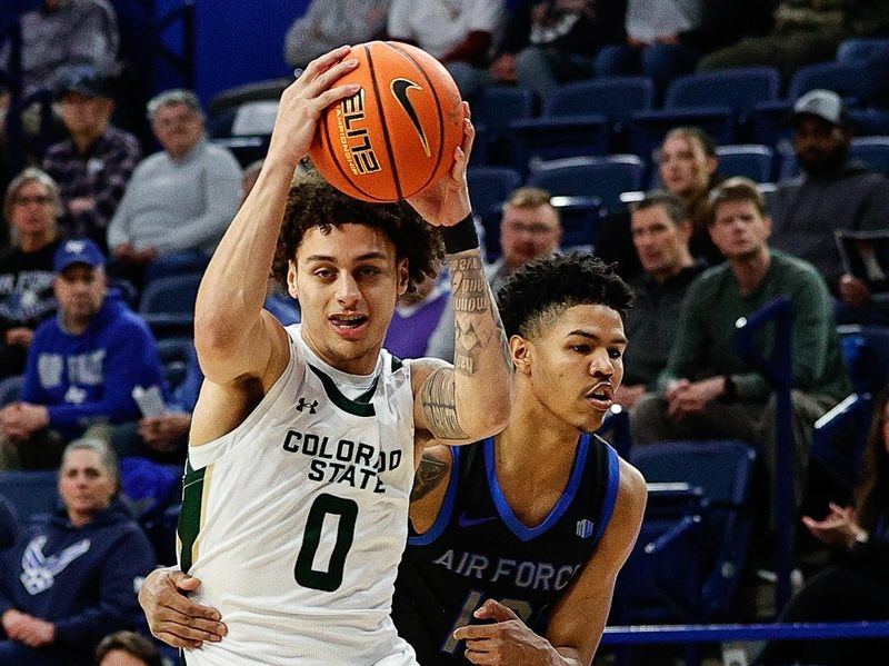 Feb 25, 2025; Colorado Springs, Colorado, USA; Colorado State Rams guard Kyan Evans (0) controls the ball ahead of Air Force Falcons guard Chase Beasley (13) in the first half at Clune Arena. Mandatory Credit: Isaiah J. Downing-Imagn Images