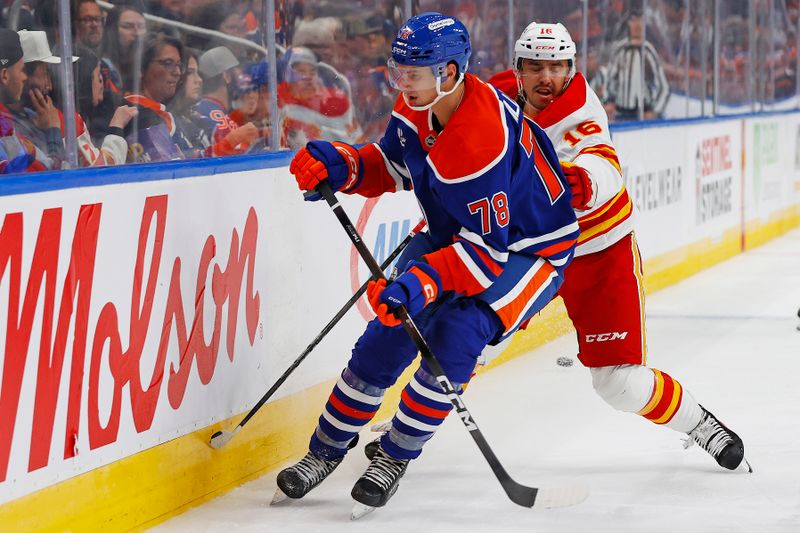 Sep 21, 2025; Edmonton, Alberta, CAN; Edmonton Oilers defensemen Mason Millman (78) and Calgary Flames forward Morgan Frost (16) battle along the boards for a loose puck during the second period at Rogers Place. Mandatory Credit: Perry Nelson-Imagn Images