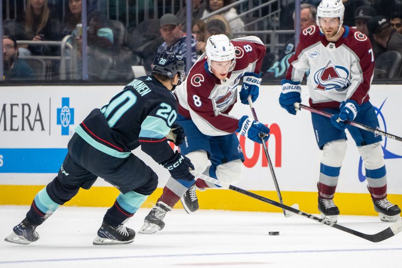 Oct 22, 2024; Seattle, Washington, USA;  Colorado Avalanche defenseman Cale Makar (8) skates against Seattle Kraken forward Eeli Tolvanen (20) during the first period at Climate Pledge Arena. Mandatory Credit: Stephen Brashear-Imagn Images