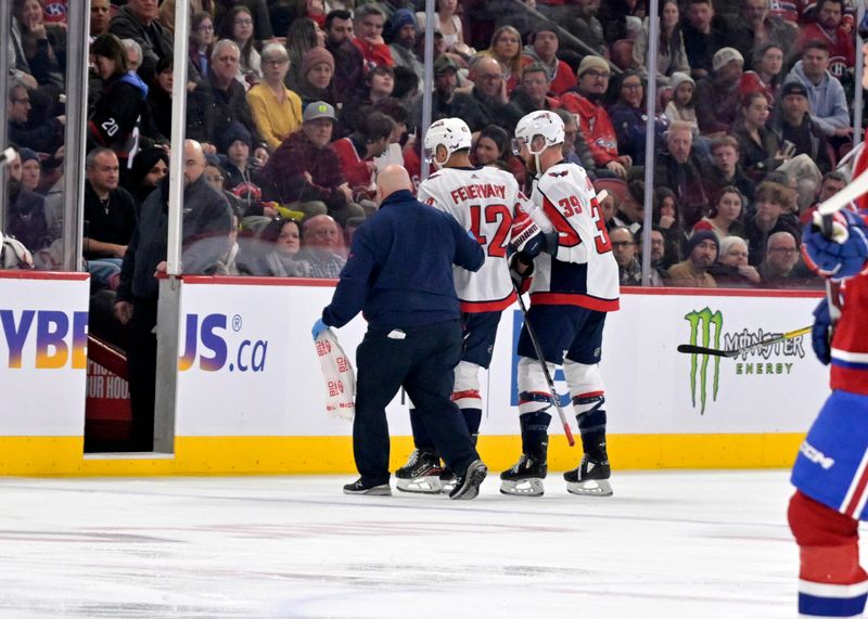 Feb 17, 2024; Montreal, Quebec, CAN; Washington Capitals defenseman Martin Fehervary (42) is helped off the ice during the first period of the game against the Montreal Canadiens at the Bell Centre. Mandatory Credit: Eric Bolte-USA TODAY Sports