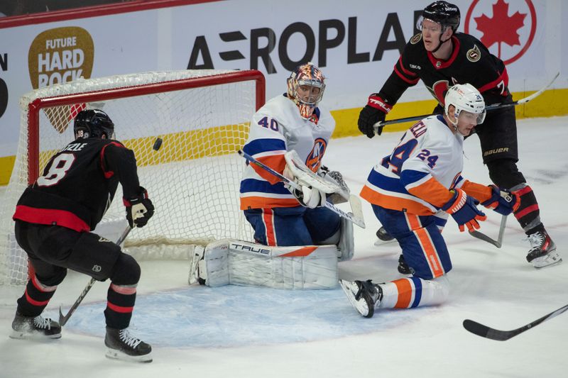 sNov 24 2023; Ottawa, Ontario, CAN; Ottawa Senators center Tim Stutzle (18) and left wing Brady Tkachuk (7) follow the puck as is travels behind New York Islanders goalie Semyon Varlamov (40) in the third period at the Canadian Tire Centre. Mandatory Credit: Marc DesRosiers-USA TODAY Sports