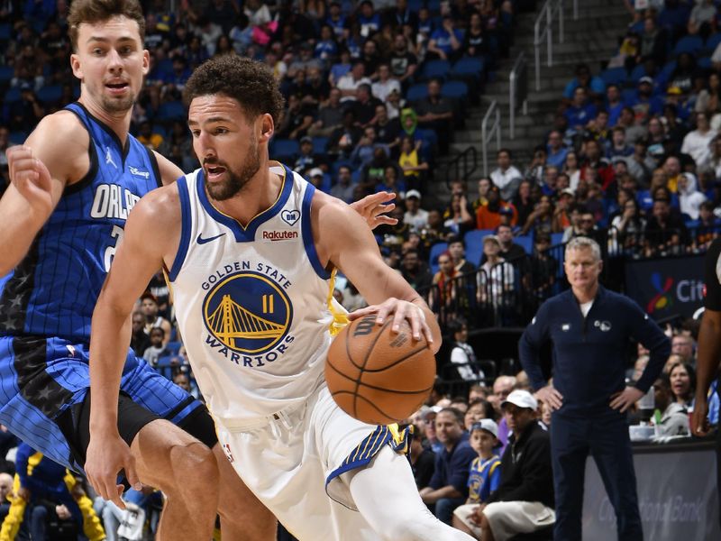 ORLANDO, FL - MARCH 27: Klay Thompson #11 of the Golden State Warriors handles the ball during the game against the Orlando Magic on March 27, 2024 at Amway Center in Orlando, Florida. NOTE TO USER: User expressly acknowledges and agrees that, by downloading and or using this photograph, User is consenting to the terms and conditions of the Getty Images License Agreement. Mandatory Copyright Notice: Copyright 2024 NBAE (Photo by Fernando Medina/NBAE via Getty Images)