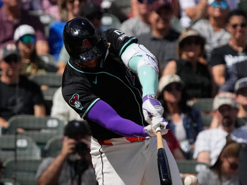 Mar 8, 2024; Salt River Pima-Maricopa, Arizona, USA; Arizona Diamondbacks left fielder Lourdes Gurriel Jr. (12) hits a double against the Chicago Cubs in the first inning at Salt River Fields at Talking Stick. Mandatory Credit: Rick Scuteri-USA TODAY Sports