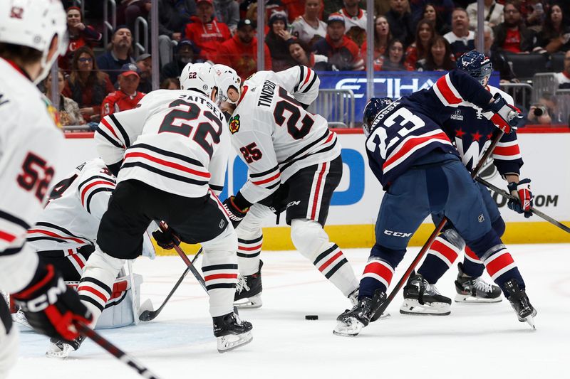 Mar 9, 2024; Washington, District of Columbia, USA; Washington Capitals center Michael Sgarbossa (23) scores a goal on Chicago Blackhawks goaltender Petr Mrazek (34) in the first period at Capital One Arena. Mandatory Credit: Geoff Burke-USA TODAY Sports