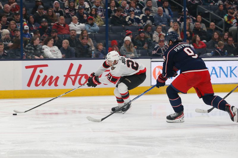 Dec 1, 2023; Columbus, Ohio, USA; Ottawa Senators right wing Mathieu Joseph (21) loses the puck as Columbus Blue Jackets defenseman Ivan Provorov (9) defends during the third period at Nationwide Arena. Mandatory Credit: Russell LaBounty-USA TODAY Sports