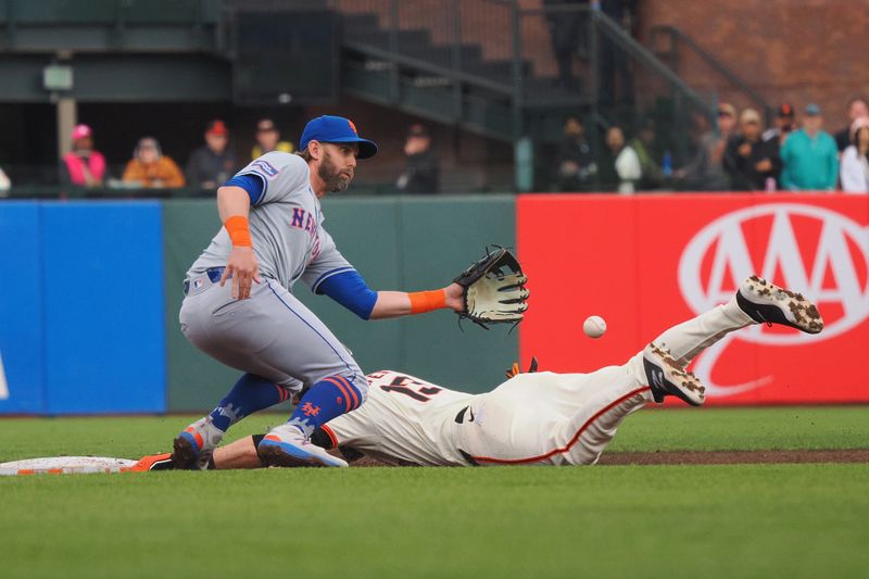 Apr 24, 2024; San Francisco, California, USA; San Francisco Giants right fielder Austin Slater (13) steals second base below New York Mets second baseman Jeff McNeil (1) during the third inning at Oracle Park. Mandatory Credit: Kelley L Cox-USA TODAY Sports