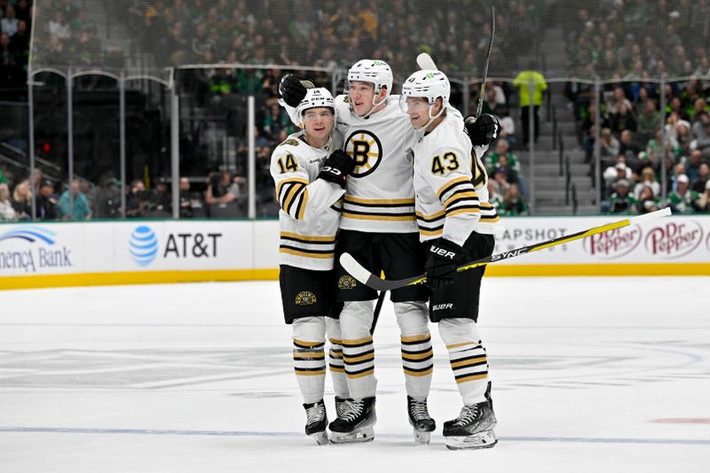 Nov 6, 2023; Dallas, Texas, USA; Boston Bruins defenseman Ian Mitchell (14) and defenseman Mason Lohrei (6) and left wing Danton Heinen (43) celebrates a goal scored by Lohrei against the Dallas Stars during the first period at the American Airlines Center. Mandatory Credit: Jerome Miron-USA TODAY Sports