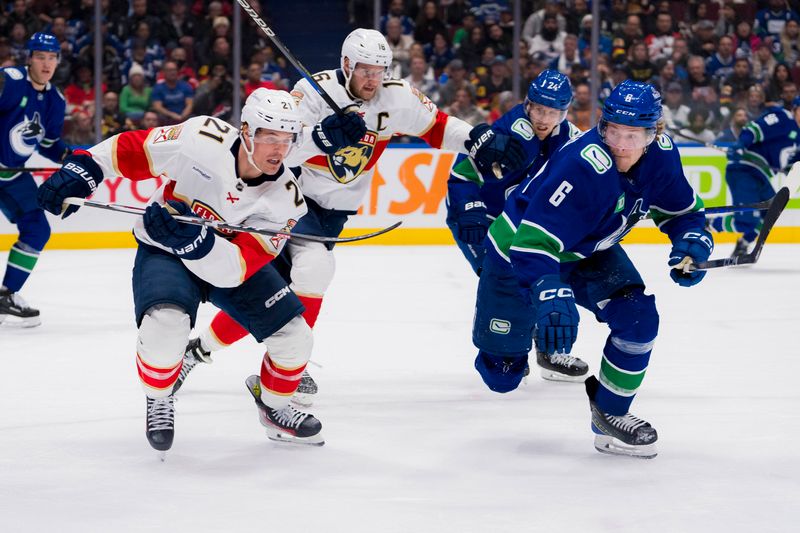 Dec 14, 2023; Vancouver, British Columbia, CAN; Florida Panthers forward Nick Cousins (21) and Vancouver Canucks forward Brock Boeser (6) skate after teh loose puck in the second period at Rogers Arena. Mandatory Credit: Bob Frid-USA TODAY Sports