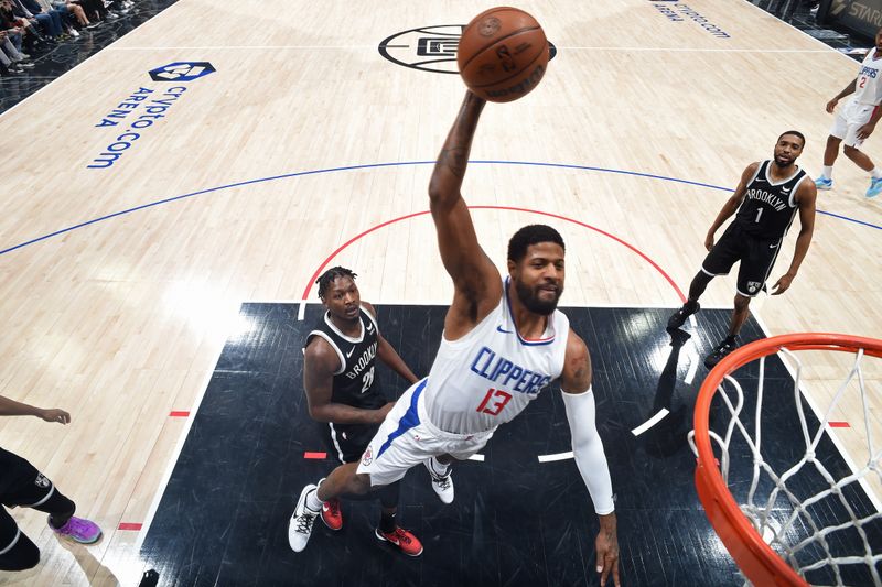 LOS ANGELES, CA - JANUARY 21: Paul George #13 of the LA Clippers dunks the ball during the game against the Brooklyn Nets on January 21, 2024 at Crypto.Com Arena in Los Angeles, California. NOTE TO USER: User expressly acknowledges and agrees that, by downloading and/or using this Photograph, user is consenting to the terms and conditions of the Getty Images License Agreement. Mandatory Copyright Notice: Copyright 2024 NBAE (Photo by Adam Pantozzi/NBAE via Getty Images)