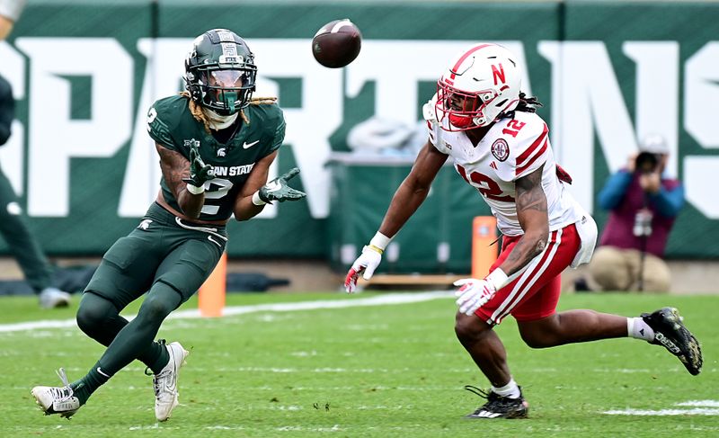 Nov 4, 2023; East Lansing, Michigan, USA; Michigan State Spartans wide receiver Tyrell Henry (2) pulls in a pass in the third quarter against Nebraska Cornhuskers defensive back Omar Brown (12) at Spartan Stadium. Mandatory Credit: Dale Young-USA TODAY Sports