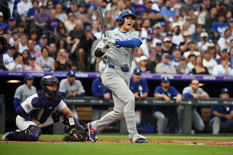 Jun 25, 2025; Denver, Colorado, USA; Los Angeles Dodgers two-way player Shohei Ohtani (17) yells as he hits a foul ball during an at bat in the third inning against the Colorado Rockies at Coors Field. Mandatory Credit: Christopher Hanewinckel-Imagn Images