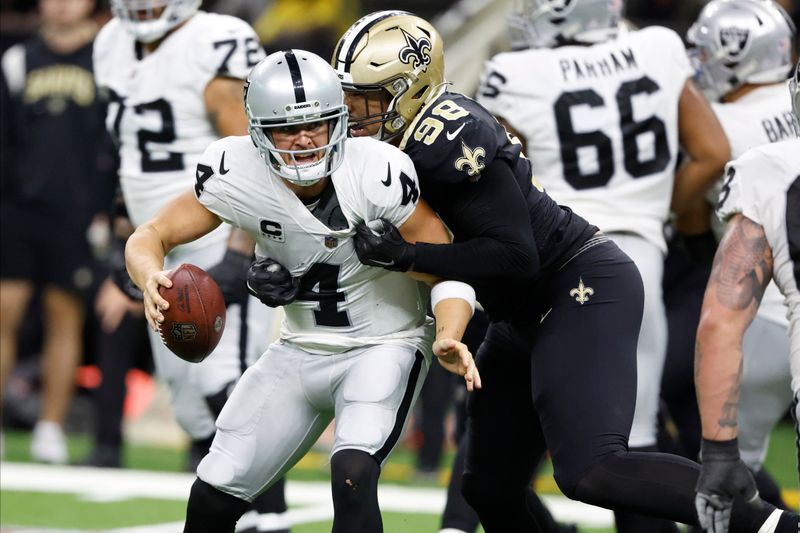 New Orleans Saints defensive end Payton Turner (98) sacks Las Vegas Raiders quarterback Derek Carr (4) during the second half of an NFL football game Sunday, Oct. 30, 2022, in New Orleans. (AP Photo/Butch Dill)