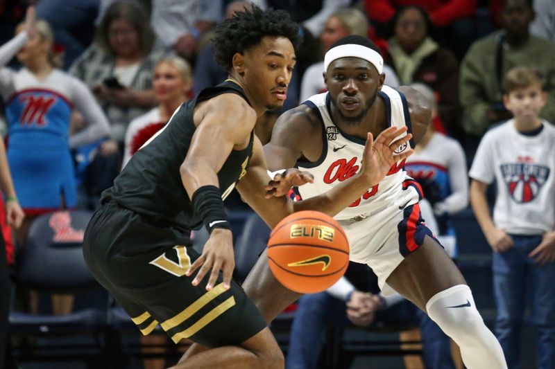 Jan 13, 2024; Oxford, Mississippi, USA; Mississippi Rebels forward Moussa Cisse (33) knocks the ball away from Vanderbilt Commodores guard Tyrin Lawrence (0) during the second half at The Sandy and John Black Pavilion at Ole Miss. Mandatory Credit: Petre Thomas-USA TODAY Sports