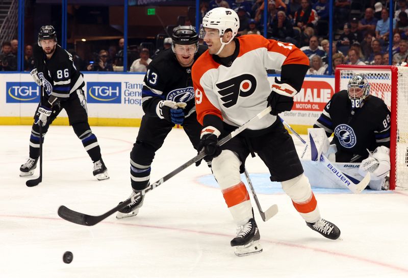 Mar 9, 2024; Tampa, Florida, USA; Philadelphia Flyers defenseman Jamie Drysdale (9) passes the puck as Tampa Bay Lightning defenseman Darren Raddysh (43) defends during the second period at Amalie Arena. Mandatory Credit: Kim Klement Neitzel-USA TODAY Sports