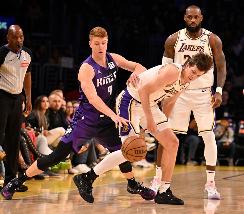 LOS ANGELES, CALIFORNIA - OCTOBER 26: Kevin Huerter #9 of the Sacramento Kings swats the ball away from Austin Reaves #15 of the Los Angeles Lakers during the first half at Crypto.com Arena on October 26, 2024 in Los Angeles, California. NOTE TO USER: User expressly acknowledges and agrees that, by downloading and or using this photograph, User is consenting to the terms and conditions of the Getty Images License Agreement. (Photo by John McCoy/Getty Images)