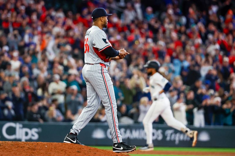 May 31, 2025; Seattle, Washington, USA; Minnesota Twins pitcher Jorge Alcala (66) walks around the mound after surrendering a two-run home run to Seattle Mariners shortstop J.P. Crawford (3, background) during the seventh inning at T-Mobile Park. Mandatory Credit: Joe Nicholson-Imagn Images
