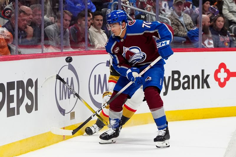 Apr 8, 2025; Denver, Colorado, USA; Colorado Avalanche defenseman Sam Malinski (70) reaches for the puck in the first period against the Vegas Golden Knights at Ball Arena. Mandatory Credit: Ron Chenoy-Imagn Images