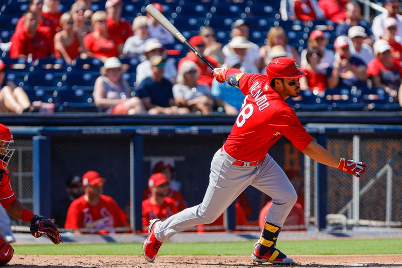 Feb 28, 2023; West Palm Beach, Florida, USA; St. Louis Cardinals third baseman Nolan Arenado (28) hits a single during the third inning against the Washington Nationals at The Ballpark of the Palm Beaches. Mandatory Credit: Sam Navarro-USA TODAY Sports