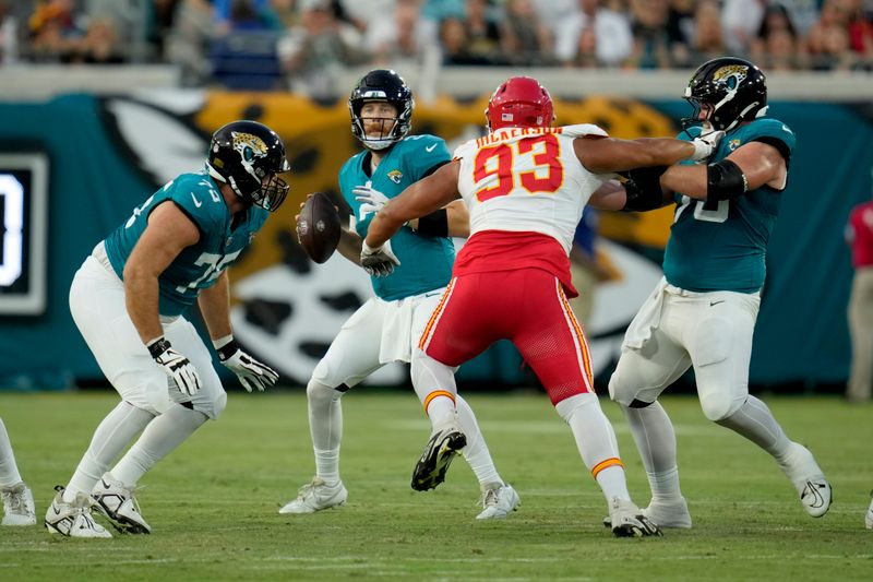 Jacksonville Jaguars quarterback C.J. Beathard drops back to pass as Kansas City Chiefs defensive tackle Matt Dickerson (93) defends during the first half of an NFL preseason football game Saturday, Aug. 10, 2024, in Jacksonville, Fla. (AP Photo/John Raoux)