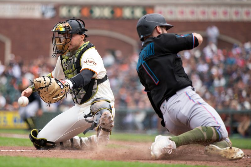 May 20, 2023; San Francisco, California, USA; Miami Marlins right fielder Garrett Hampson (1) slides safely home on a single by Jon Berti as San Francisco Giants catcher Patrick Bailey (14) is unable to handle the relay during the eighth inning at Oracle Park. Mandatory Credit: D. Ross Cameron-USA TODAY Sports