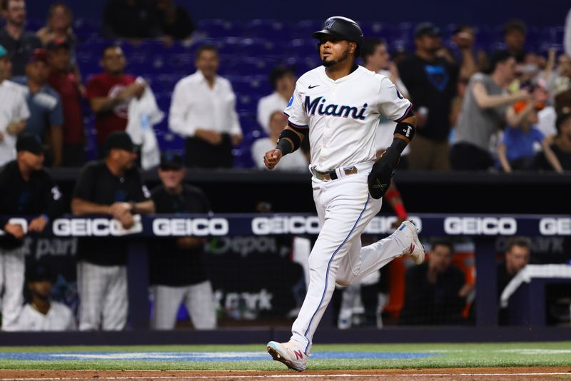 May 1, 2024; Miami, Florida, USA; Miami Marlins second baseman Luis Arraez (3) scores against the Colorado Rockies during the fifth inning at loanDepot Park. Mandatory Credit: Sam Navarro-USA TODAY Sports