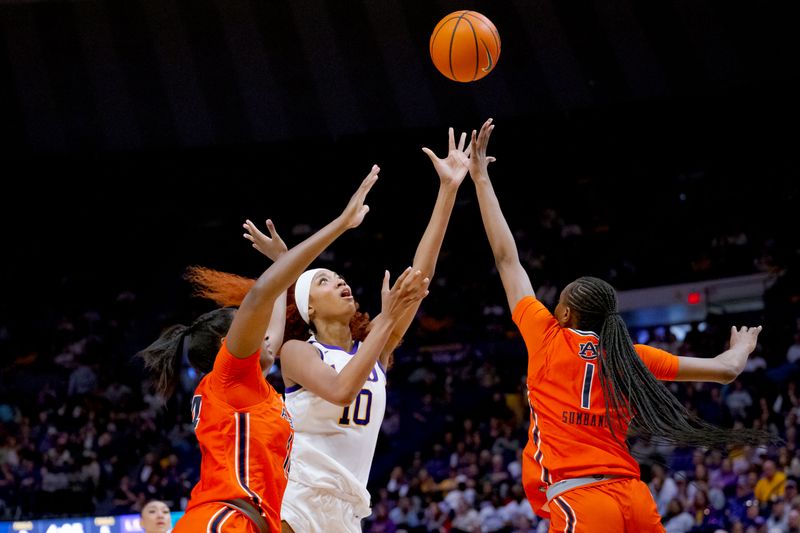 Feb 22, 2024; Baton Rouge, Louisiana, USA; LSU Lady Tigers forward Angel Reese (10) shoots against Auburn Tigers forward Taylen Collins (14) and forward Celia Sumbane (1) during the second half at Pete Maravich Assembly Center. Mandatory Credit: Matthew Hinton-USA TODAY Sports