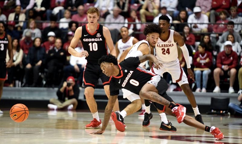 Feb 18, 2023; Tuscaloosa, Alabama, USA;  Georgia guard Terry Roberts (0) scrambles to get a loose ball as he is defended by Alabama guard Mark Sears (1) at Coleman Coliseum. Mandatory Credit: Gary Cosby Jr.-USA TODAY Sports