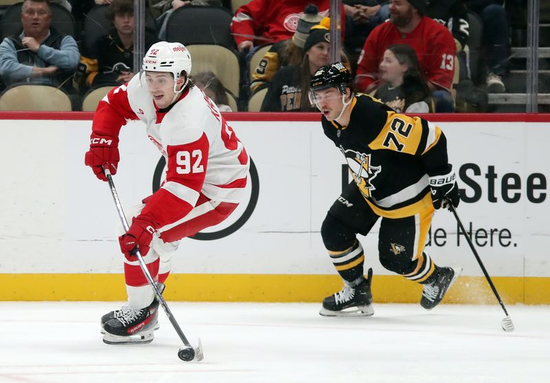 Nov 13, 2024; Pittsburgh, Pennsylvania, USA;  Detroit Red Wings center Marco Kasper (92) moves the puck against Pittsburgh Penguins left wing Anthony Beauvillier (72) during the third period at PPG Paints Arena. Mandatory Credit: Charles LeClaire-Imagn Images