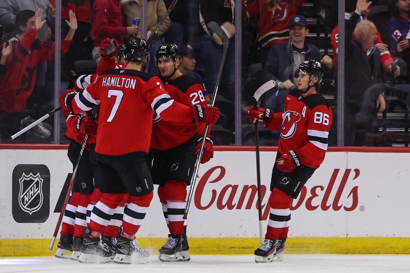 Oct 25, 2024; Newark, New Jersey, USA; The New Jersey Devils celebrate a goal by New Jersey Devils left wing Jesper Bratt (63) against the New York Islanders during the third period at Prudential Center. Mandatory Credit: Ed Mulholland-Imagn Images