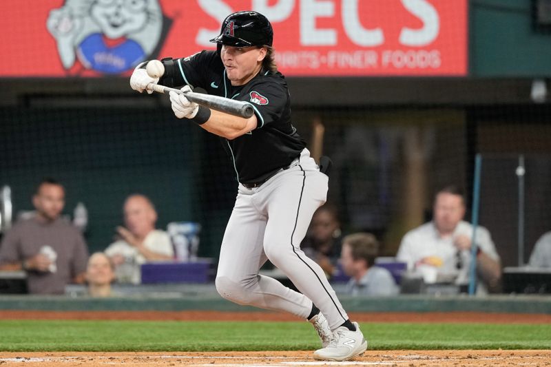 May 29, 2024; Arlington, Texas, USA; Arizona Diamondbacks shortstop Kevin Newman (18) attempts a bunt against the Texas Rangers during the second inning at Globe Life Field. Mandatory Credit: Jim Cowsert-USA TODAY Sports