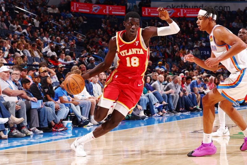 OKLAHOMA CITY, OK - OCTOBER 17: Mouhamed Gueye #18 of the Atlanta Hawks dribbles the ball during the game against the Oklahoma City Thunder on October 17, 2024 at Paycom Arena in Oklahoma City, Oklahoma. NOTE TO USER: User expressly acknowledges and agrees that, by downloading and or using this photograph, User is consenting to the terms and conditions of the Getty Images License Agreement. Mandatory Copyright Notice: Copyright 2024 NBAE (Photo by Zach Beeker/NBAE via Getty Images)