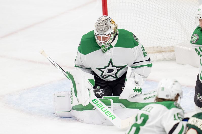 Apr 6, 2025; Saint Paul, Minnesota, USA; Dallas Stars goaltender Jake Oettinger (29) watches a shot from the Minnesota Wild in the first period at Xcel Energy Center. Mandatory Credit: Matt Blewett-Imagn Images