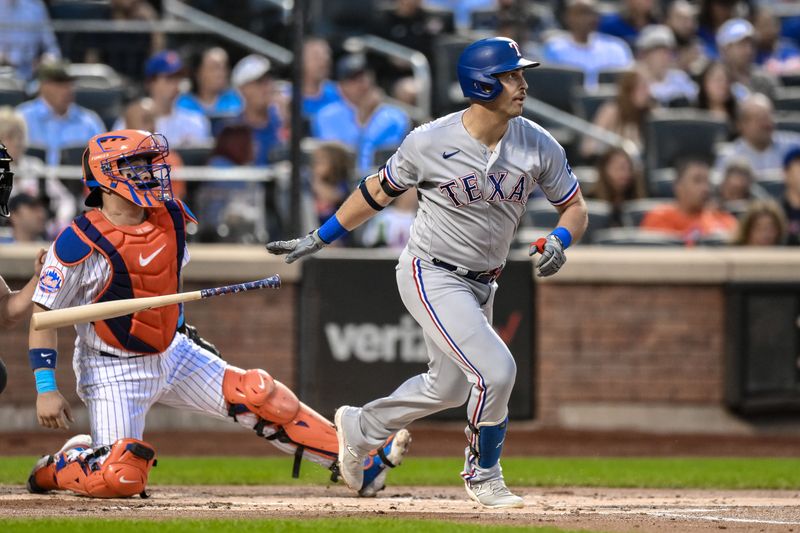 Aug 29, 2023; New York City, New York, USA; Texas Rangers first baseman Nathaniel Lowe (30) hits a double against the New York Mets during the first inning at Citi Field. Mandatory Credit: John Jones-USA TODAY Sports