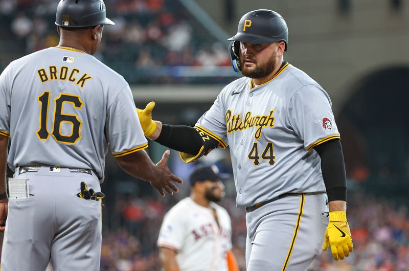 Jul 30, 2024; Houston, Texas, USA; Pittsburgh Pirates first baseman Rowdy Tellez (44) celebrates with first base coach Tarrik Brock (16) after a single during the first inning against the Houston Astros at Minute Maid Park. Mandatory Credit: Troy Taormina-USA TODAY Sports