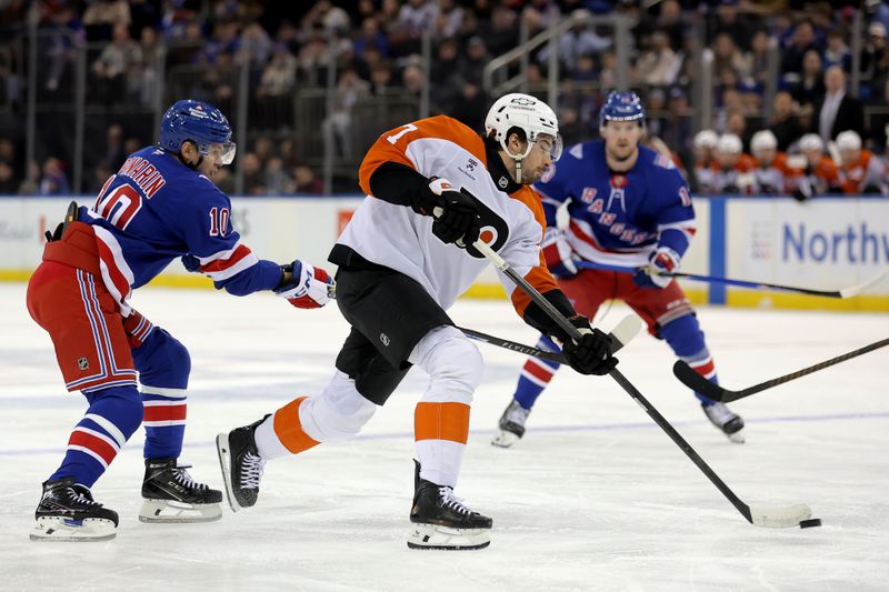 Dec 20, 2025; New York, New York, USA; Philadelphia Flyers left wing Noah Cates (27) shoots the puck against New York Rangers left wing Artemi Panarin (10) during the first period at Madison Square Garden. Mandatory Credit: Brad Penner-Imagn Images