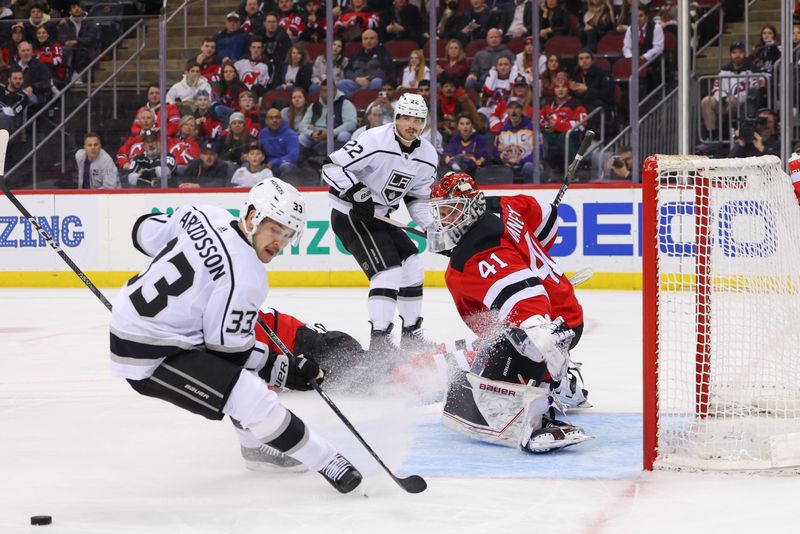 Feb 23, 2023; Newark, New Jersey, USA; Los Angeles Kings right wing Viktor Arvidsson (33) looks for the puck while New Jersey Devils goaltender Vitek Vanecek (41) defends his net during the first period at Prudential Center. Mandatory Credit: Ed Mulholland-USA TODAY Sports