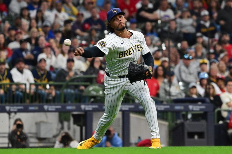 May 11, 2024; Milwaukee, Wisconsin, USA; Milwaukee Brewers pitcher Freddy Peralta (51) commits a throwing error on a sacrifice bunt by St. Louis Cardinals shortstop Masyn Winn (not pictured) in the fifth inning at American Family Field. Mandatory Credit: Benny Sieu-USA TODAY Sports