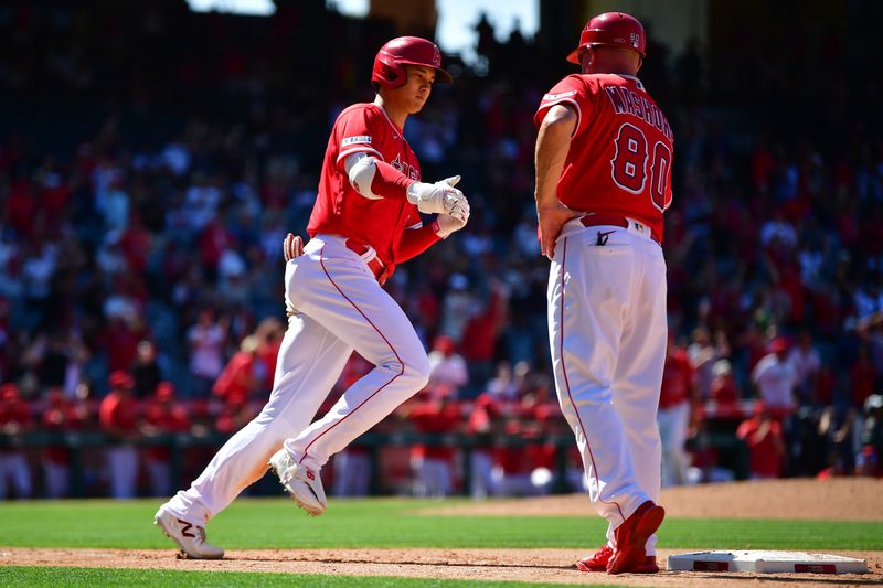 Jun 29, 2023; Anaheim, California, USA; Los Angeles Angels designated hitter Shohei Ohtani (17) is greeted by first base coach Damon Mashore (80) after hitting a two run home run against the Chicago White Sox during the ninth inning at Angel Stadium. Mandatory Credit: Gary A. Vasquez-USA TODAY Sports