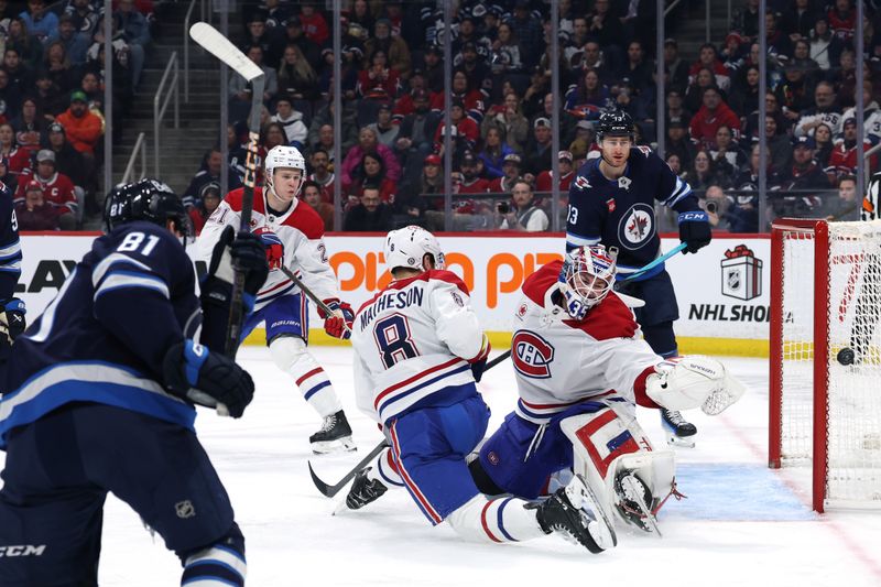 Dec 14, 2024; Winnipeg, Manitoba, CAN; Winnipeg Jets left wing Kyle Connor (81) shoots wide of Montreal Canadiens goaltender Sam Montembeault (35) in the second period at Canada Life Centre. Mandatory Credit: James Carey Lauder-Imagn Images