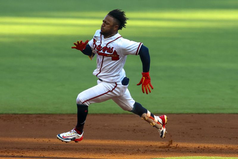 Jun 27, 2023; Atlanta, Georgia, USA; Atlanta Braves second baseman Ozzie Albies (1) hits a triple against the Minnesota Twins in the first inning at Truist Park. Mandatory Credit: Brett Davis-USA TODAY Sports
