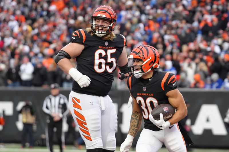 Cincinnati Bengals running back Chase Brown (30) celebrates Gus rushing touchdown with Cincinnati Bengals guard Alex Cappa (65) during an NFL football game against the Indianapolis Colts, Sunday, Dec. 10, 2023, in Cincinnati, OH. (AP Photo/Peter Joneleit)