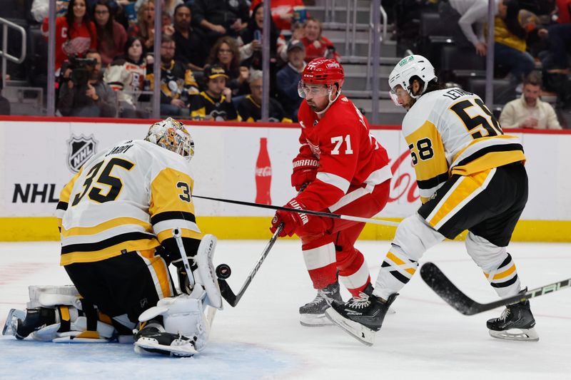 Oct 18, 2023; Detroit, Michigan, USA; Pittsburgh Penguins goaltender Tristan Jarry (35) makes a save on Detroit Red Wings center Dylan Larkin (71) in the second period at Little Caesars Arena. Mandatory Credit: Rick Osentoski-USA TODAY Sports