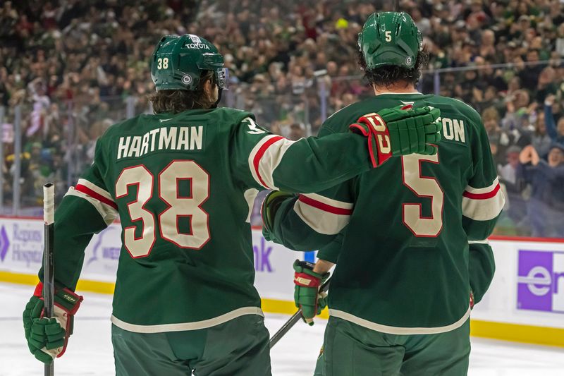 Nov 25, 2024; Saint Paul, Minnesota, USA;  Minnesota Wild forward Ryan Hartman (38) congratulates defenseman Jacob Middleton (5) on his goal against the Winnipeg Jets during the first period at Xcel Energy Center. Mandatory Credit: Nick Wosika-Imagn Images