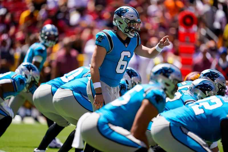 Carolina Panthers quarterback Baker Mayfield (6) directs his team during the first half of a NFL preseason football game against the Washington Commanders, Saturday, Aug. 13, 2022, in Landover, Md. (AP Photo/Alex Brandon)