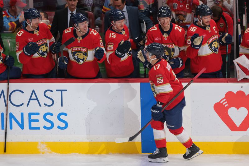 Jan 16, 2025; Sunrise, Florida, USA; Florida Panthers center Evan Rodrigues (17) celebrates with teammates after scoring against the Detroit Red Wings during the second period at Amerant Bank Arena. Mandatory Credit: Sam Navarro-Imagn Images