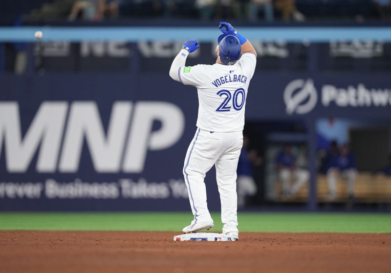 May 1, 2024; Toronto, Ontario, CAN; Toronto Blue Jays designated hitter Daniel Vogelbach (20) celebrates hitting a double against the Kansas City Royals during the ninth inning at Rogers Centre. Mandatory Credit: Nick Turchiaro-USA TODAY Sports