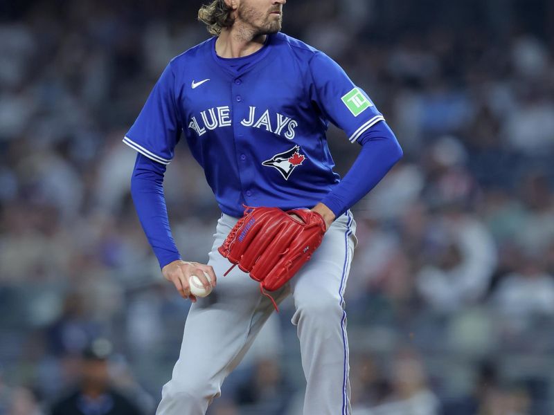 Sep 5, 2025; Bronx, New York, USA; Toronto Blue Jays starting pitcher Kevin Gausman (34) pitches against the New York Yankees during the first inning at Yankee Stadium. Mandatory Credit: Brad Penner-Imagn Images