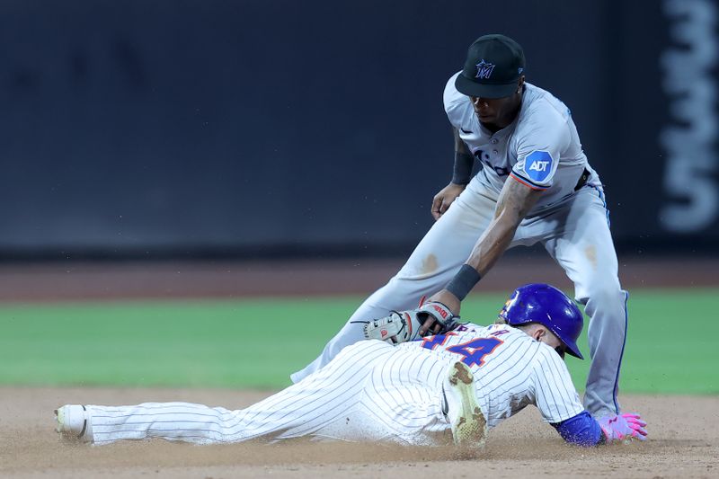 Jun 13, 2024; New York City, New York, USA; New York Mets center fielder Harrison Bader (44) is tagged out trying to steal second base by Miami Marlins shortstop Tim Anderson (7) during the sixth inning at Citi Field. Mandatory Credit: Brad Penner-USA TODAY Sports