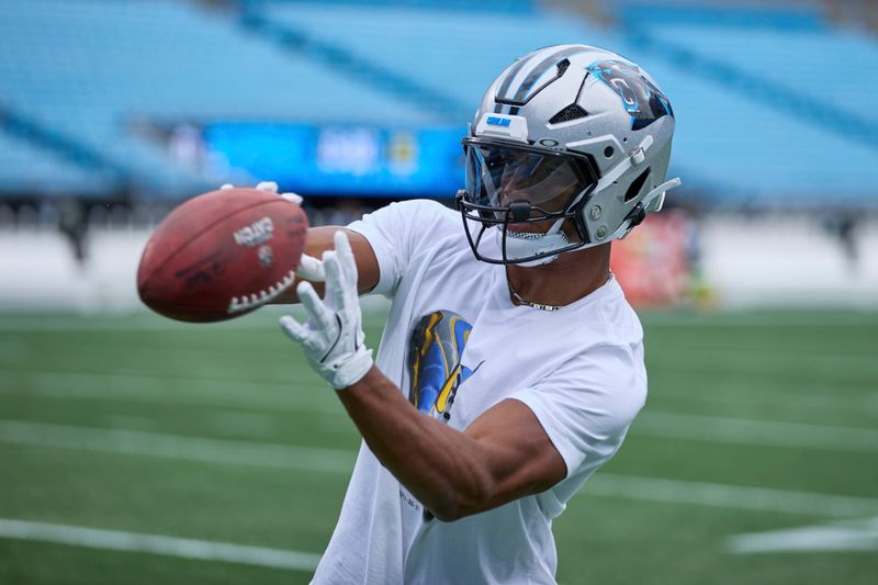 Carolina Panthers running back Chuba Hubbard (30) catches a football prior to an NFL Football game against the Los Angeles Chargers, Sunday, Sep. 15, 2024, in Charlotte, N.C. (AP Photo/Brian Westerholt)